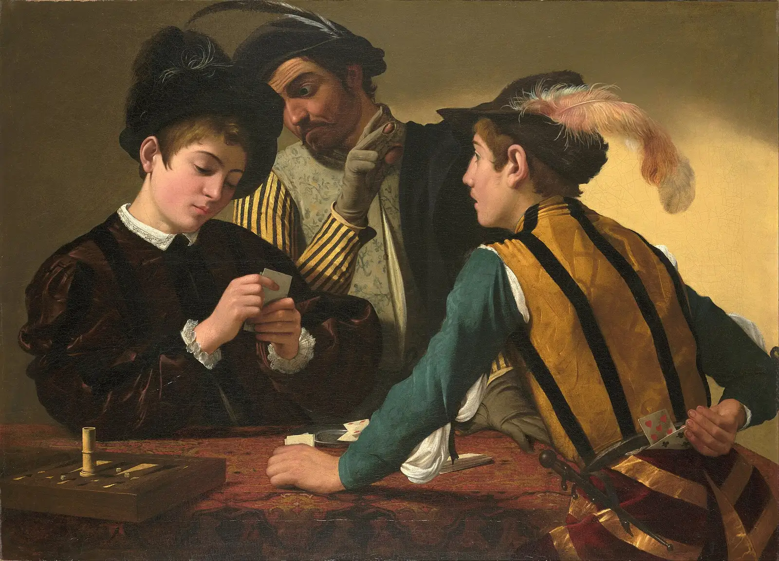 Young man studies his cards; behind him a gloved man leans in, and another youth hides cards behind his back