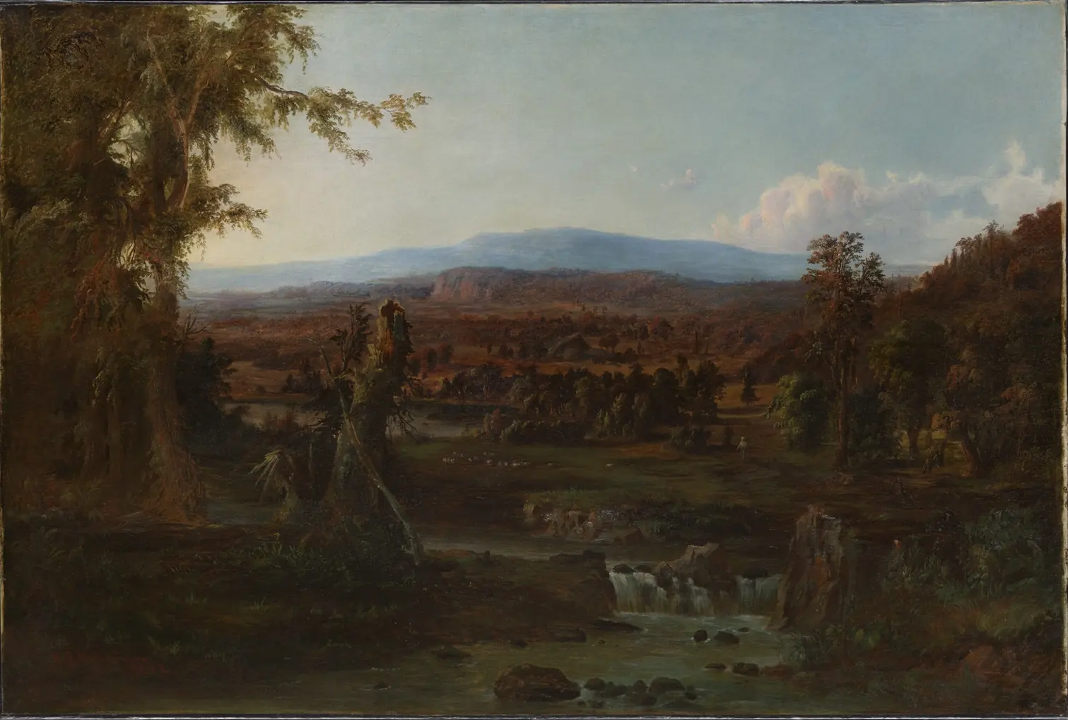 Broad valley with a stream and small cascades in front, dark trees at the sides and a blue mountain in the distance