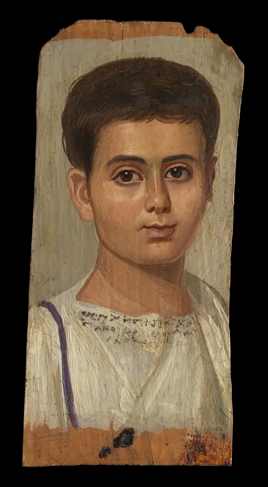 Boy with short brown hair and large dark eyes in a white tunic with a purple stripe, Greek letters across his chest
