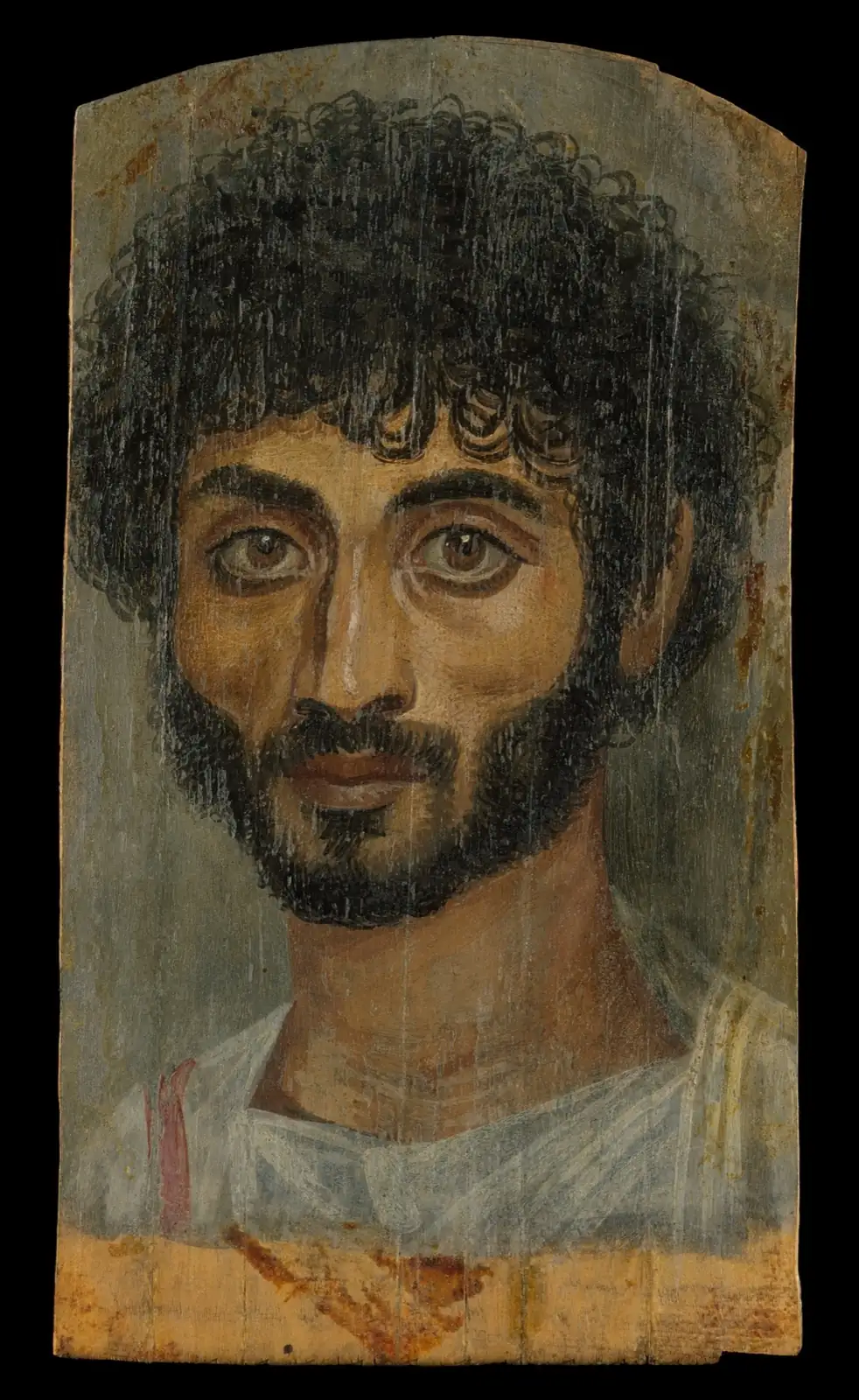 Thin-faced man with thick curly black hair, a full beard, large brown eyes and a white tunic against a gray ground