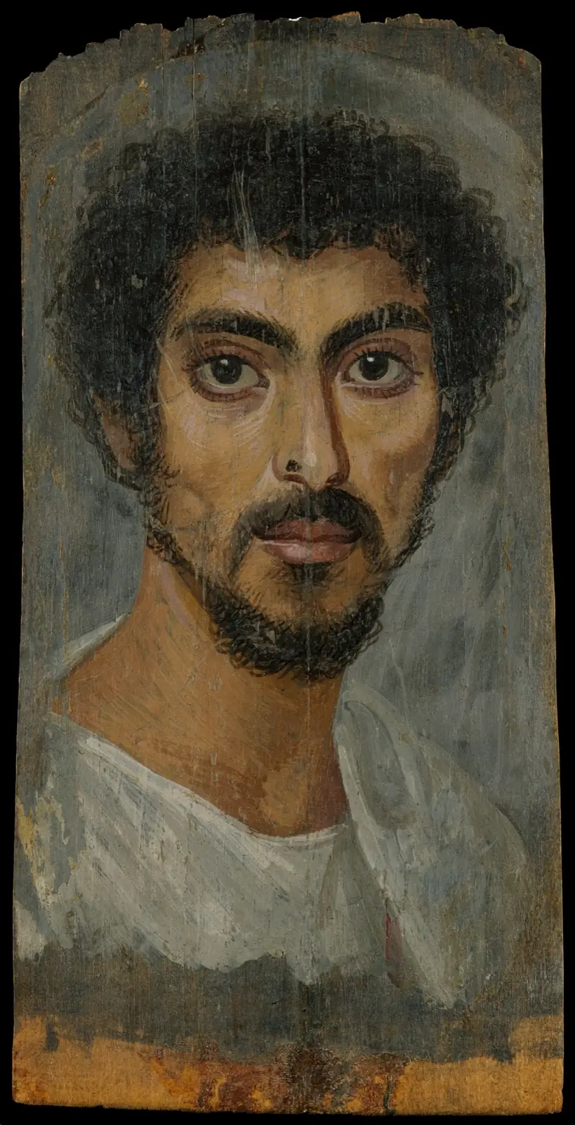Man with curly black hair, a short beard and moustache, large dark eyes and a white tunic against a blue-gray ground