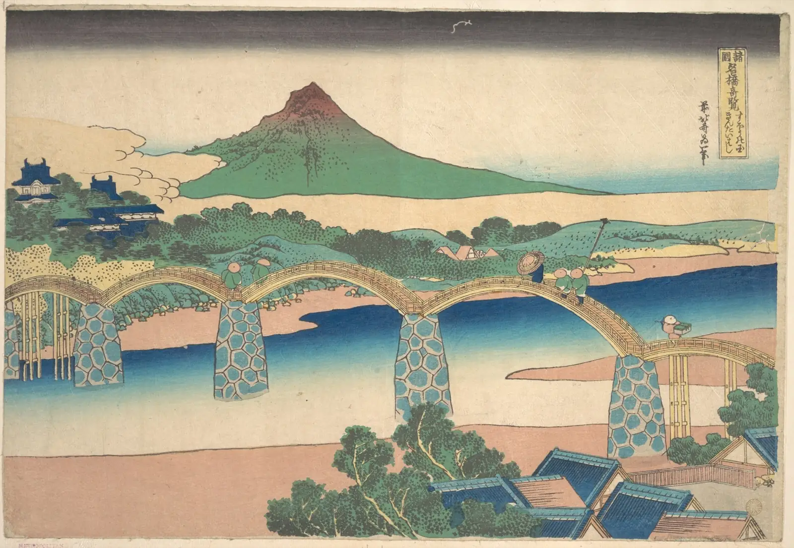 Wooden bridge of high arches on stone piers spanning a blue river, with a green mountain in the distance