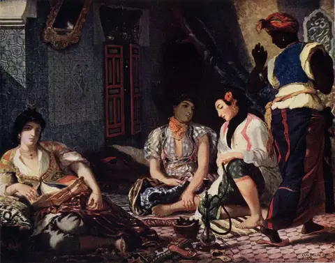Three women in embroidered clothes seated on carpets in a tiled room, with a water pipe and a standing servant
