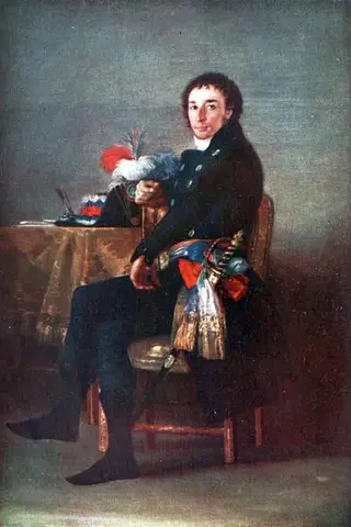 Man in a dark coat seated sideways on a chair beside a table holding a plumed hat and an inkwell