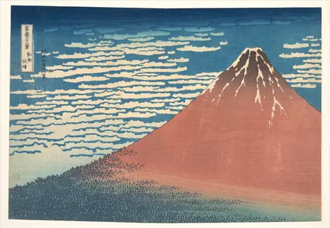 Monte Fuji de color rojo óxido con nieve en la cima, bajo un cielo azul lleno de hileras de nubes blancas
