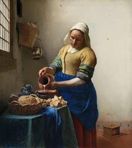 Mujer de blusa amarilla y delantal azul vierte leche de una jarra de barro en un recipiente, junto a una ventana