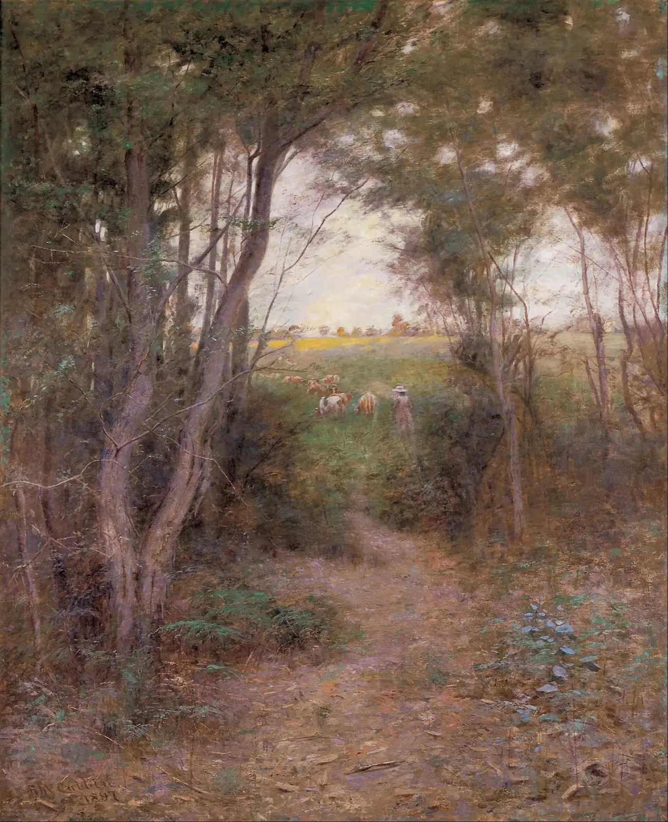 Path through trees opening onto a sunny meadow with cows and a small figure in a hat in the distance