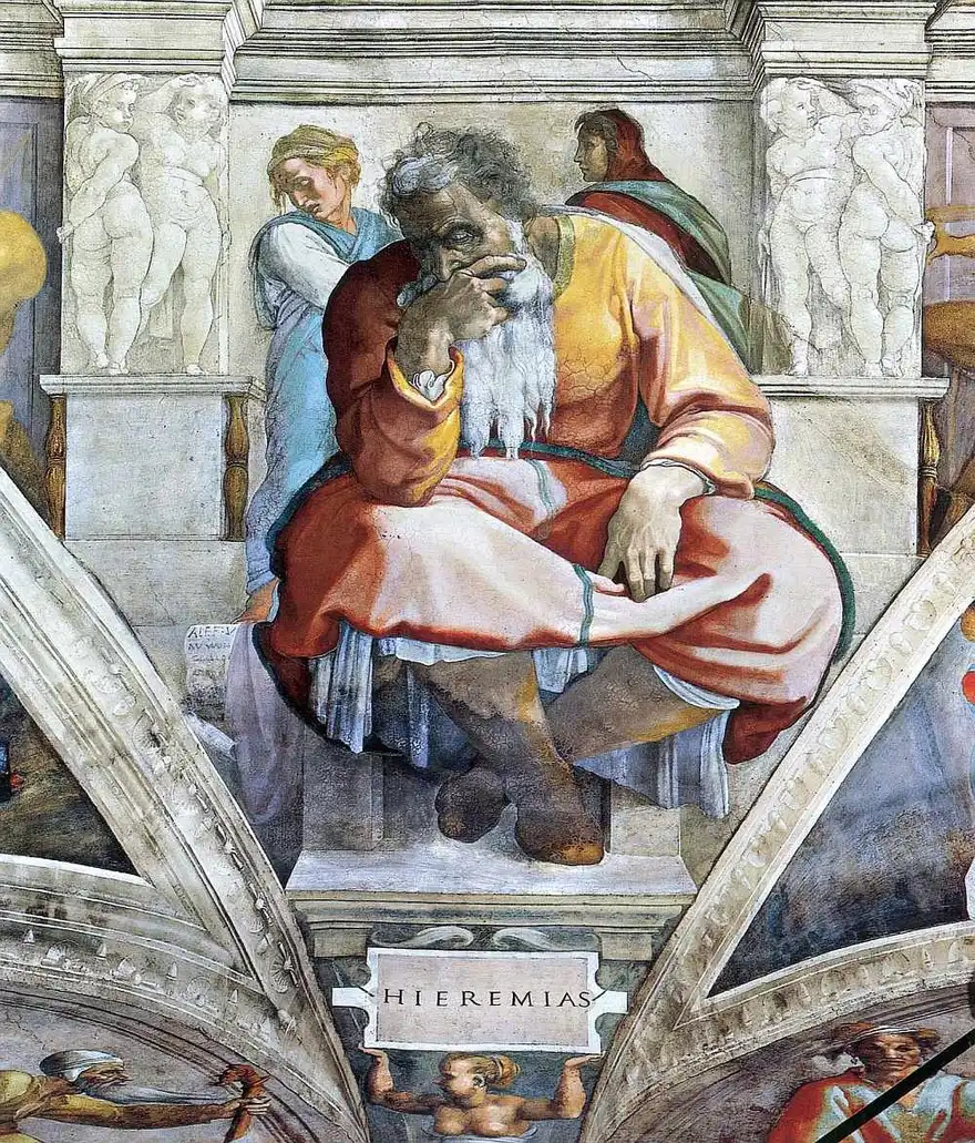 White-bearded old man seated and hunched, hand over his mouth and eyes downcast, on a stone throne