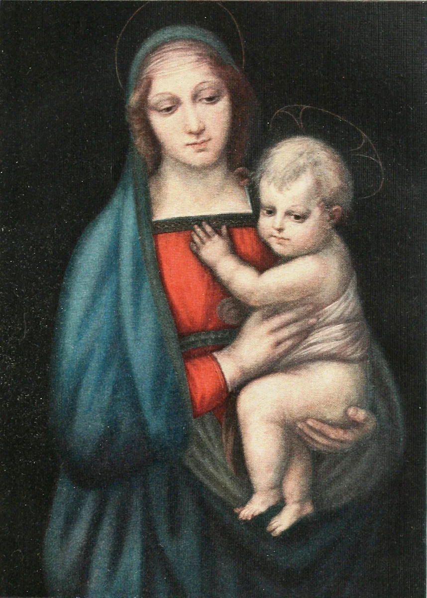 Woman in a blue-green mantle and red dress, eyes lowered, holding a child in her arms against a dark background