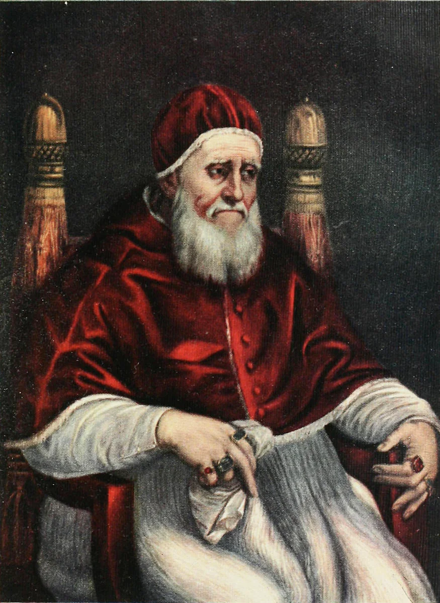 White-bearded old man in a red velvet cap and cape, seated in a chair with gilded finials, looking down