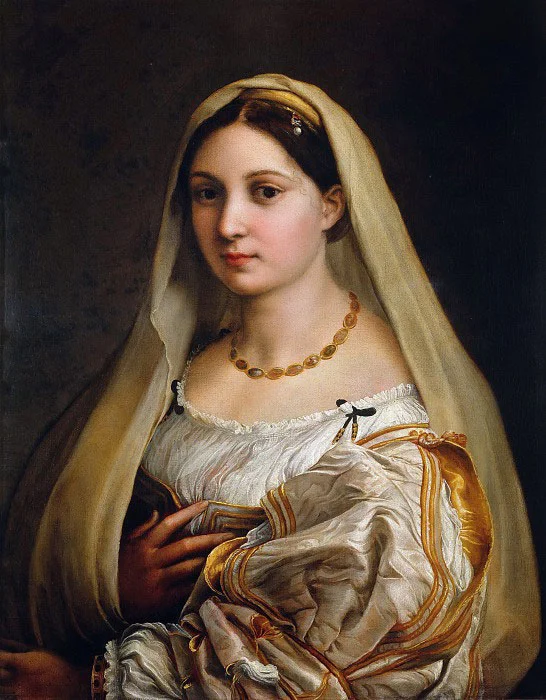 Young woman in a pale veil and amber bead necklace, with a white blouse and golden sleeves, a hand on her chest