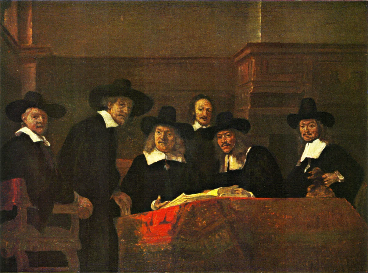 Six men in black, five in broad-brimmed hats, gathered behind a table with a red cloth and an open book